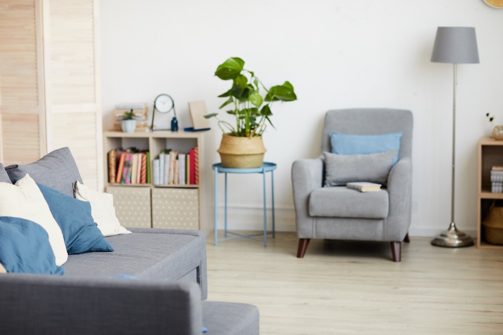 Comfortable grey sofa with blue pillows in therapy office